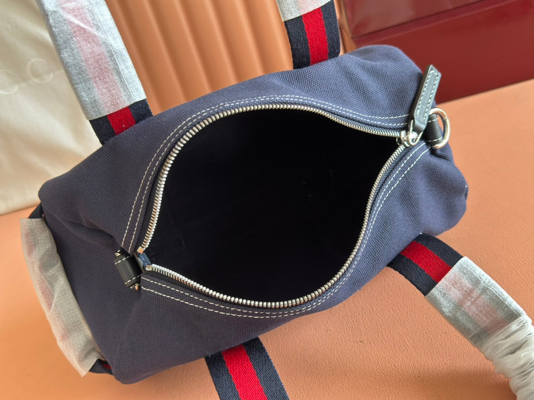 Gucci Spring Summer 2025 Men's Navy Canvas Travel Bag | Blue Leather Trim, Red-Green Web Strap, "Made in Italy" Emblem