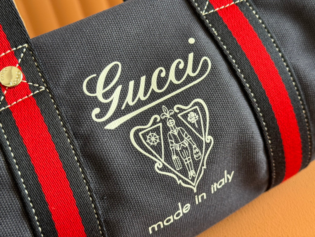 Gucci Spring Summer 2025 Men's Navy Canvas Travel Bag | Blue Leather Trim, Red-Green Web Strap, "Made in Italy" Emblem