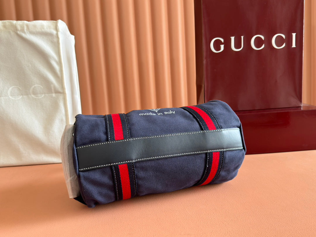 Gucci Spring Summer 2025 Men's Navy Canvas Travel Bag | Blue Leather Trim, Red-Green Web Strap, "Made in Italy" Emblem