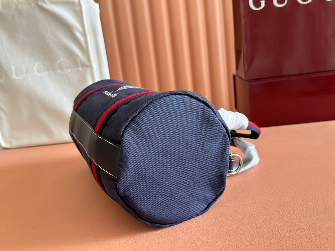 Gucci Spring Summer 2025 Men's Navy Canvas Travel Bag | Blue Leather Trim, Red-Green Web Strap, "Made in Italy" Emblem