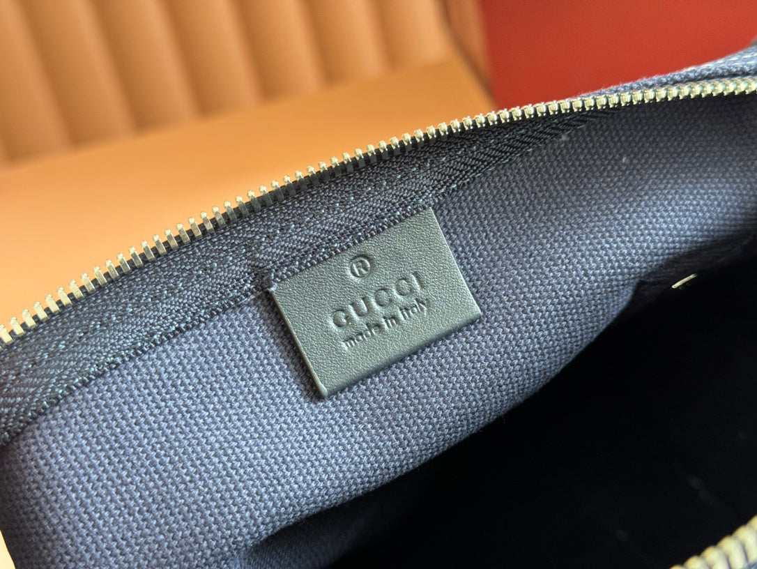 Gucci Spring Summer 2025 Men's Navy Canvas Travel Bag | Blue Leather Trim, Red-Green Web Strap, "Made in Italy" Emblem